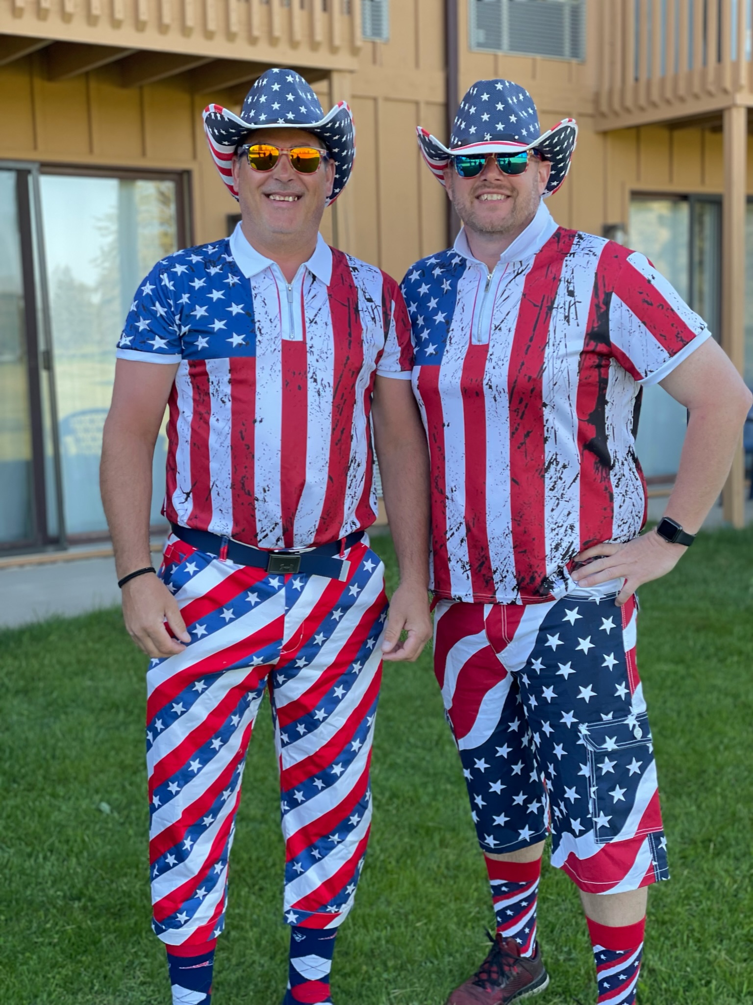 Two Team Jake players in matching flag shirts, flag trousers, patriotic cowboy hats, and sunglasses