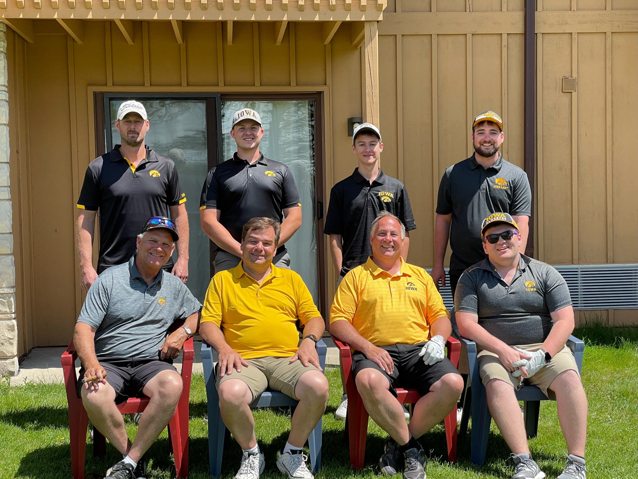 Team Austin posing outside the villa in black and gold Iowa uniforms